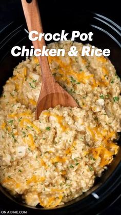 a wooden spoon in a slow cooker filled with rice and cheese, ready to be cooked