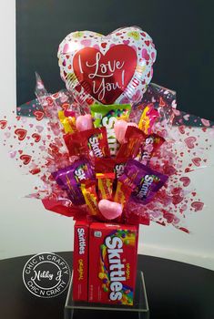 valentine's day candy bouquet with balloons and heart - shaped balloons