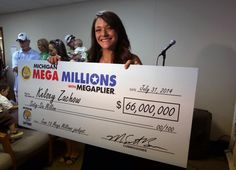 a woman holding up a large check for $ 600, 000 in megamillions