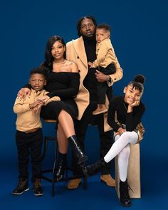 a family posing for a photo in front of a blue background