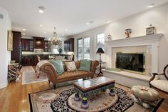 a living room filled with furniture and a fire place