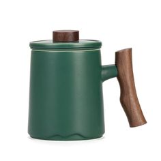 a green coffee pot with a wooden handle