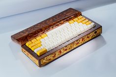 an old computer keyboard sitting on top of a wooden box with yellow and white keys