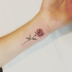 a small rose tattoo on the wrist