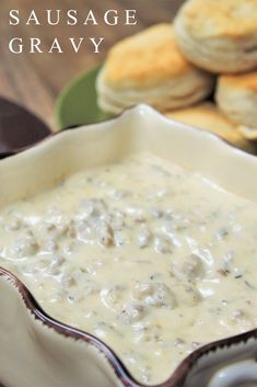 sausage gravy in a white bowl with biscuits on the side and text overlay that reads sausage gravy