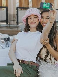 two women sitting next to each other at a table