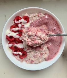 a bowl filled with yogurt and raspberries