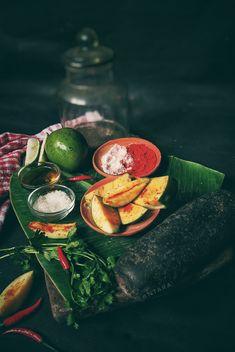 an assortment of fruits and vegetables on a plate with some sauces next to it