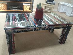 a glass table with magazines on it in a living room