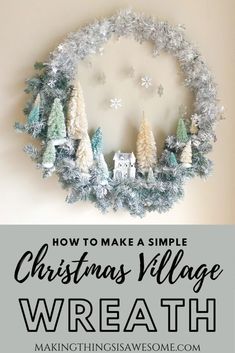 a christmas wreath hanging on the wall with text overlay how to make a simple christmas village wreath