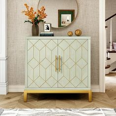 a white and gold cabinet in a living room