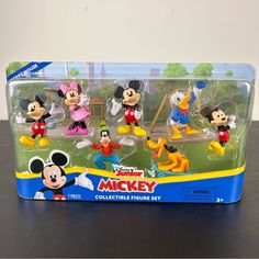 mickey mouse figurines are in a plastic case