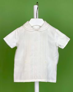 An elegant two-piece set for baby boys to wear during any special occasion. The top has a peter pan collar, frontal lace, handmade pleats, and short sleeves; it has buttons on the back for closure. The bottom is bubble shorts with buttons on the sides for closure and an elastic band on the back. The interior, or lining, is made with cotton fabric, while the exterior is with off-white organza. Dry clean 2 piece set Interior: 100% cotton; exterior: 100% polyester Made in Spain Final Sale White Lace Shorts Outfit, Baptism Outfits For Boys, White Lace Outfit, Lace Short Outfits, Communion Headpiece, Spanish Outfits, Bubble Clothes, Bubble Shorts, Boy Christening Outfit