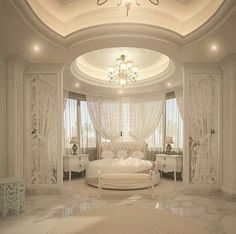 a bedroom with white furniture and chandelier in the ceiling, along with marble flooring