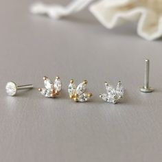 This is a set of a mini CZ tiara ear piercing jewelry removable end, which has three AAA marquise CZ diamonds, with a threadless push back post. RECOMMENDED WEARING POSITION EAR PIERCING - Helix, Earhead/Forward Helix - Tragus, Anti-Tragus/Surface Tragus - Cartilage/Flat - Conch, Inner Conch, Outer Conch - Lobe/Standard Lobe, Upper Lobe MATERIAL - AAA Cubic Zirconia - 925 sterling silver with gold/rose gold plated - 925 sterling silver threadless push back post MEASUREMENT * Removable End Size:- Elegant Hypoallergenic Nose Rings For Gifts, Elegant Nose Studs For Gift, Gift Cartilage Earrings With Sparkling Stones, Elegant Hypoallergenic Nose Studs As Gift, Hypoallergenic Nose Rings For Anniversary, Elegant Silver Nose Ring With Prong Setting, Dainty Cubic Zirconia Wedding Piercings, Cubic Zirconia Cartilage Earrings For Wedding, Elegant Nose Studs For Weddings