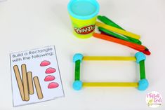 this is an image of a play doh with popsicle sticks and building blocks