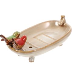 a ceramic boat with two birds on it