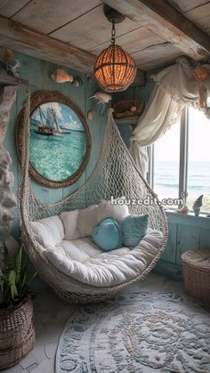 a room with a hammock hanging from the ceiling next to a large window