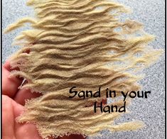 someone holding sand in their hand with the words sand in your hand written below it