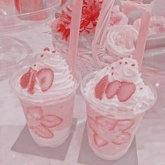 two cups filled with ice cream and strawberries