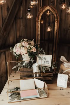 the table is set up with flowers and cards for guests to write their names on