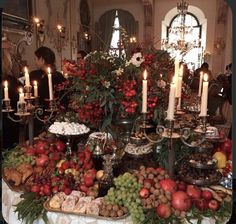 a table filled with lots of food and candles