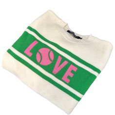 a green and white sweater with the word love printed on it's chest, in front of a white background