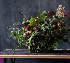 a large bouquet of flowers sitting on top of a wooden table