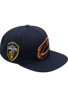 Wear your Cavaliers style with pride in this Cleveland Cavaliers Pro Standard Black Club Logo Snapback Hat! This Cleveland Cavaliers Snapback Hat features a embriodered team logo on front panels with team embriodery on right wear side. Go Cavaliers!! Pro Standard Fashion Snapback, Front embroidered team logo, Fashion accents on crown and visor, Snap closure, Fashion forward style, Polyester, Wipe clean with cloth or cleaning kit, 4 Navy Snapback Hat With Flat Bill For Fans, Navy Snapback Hat For Game Day, Team-colored Six-panel Snapback Hat For Fan Gear, Collegiate Hats With Logo Patch For Game Day, Collegiate Snapback Hat With Flat Brim For Fans, Collegiate Snapback Hat With Flat Brim, Collegiate Style Snapback Hat With Flat Brim For Fans, Navy Snapback Hat With Flat Brim For Sports Events, Navy Flat Brim Snapback Hat For Sports Events