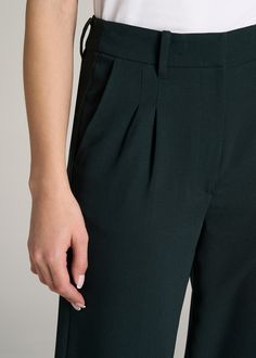 About Our Extra-Long Women’s Dress Pants Make a statement in these stylish pleated women’s tall dress pants. Pleated trousers are a timeless trend you’ll love and now, there’s finally a pair that will accentuate your long legs. These pants for tall women have been designed specifically for ladies between 5’9” and 6’6”, with a full length offering extra-long inseam options. They have a high-rise silhouette that gives the appearance of a cinched waist, complete with a fly zipper and hook and bar c Pleated Wide Leg Pants For Fall, Elegant High Waist Bottoms With Pleated Hem, Elegant High-waist Bottoms With Pleated Hem, Elegant Wide Leg Pants For Date Night, Elegant Wide-leg Pants For Date Night, Pleated Wide-leg Pants For Night Out, Fitted High-waisted Wide Leg Pants With Pleated Waist, Elegant Bottoms With Pleated Waist For Night Out, Fitted Pleated Wide Leg Ankle-length Pants