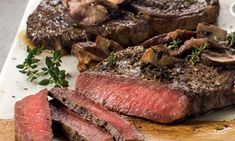 steak with mushrooms and herbs on a cutting board