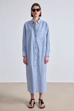 100% Organic Cotton Made in India Shirt collar, front button placket, relaxed dropped shoulder, oversized silhouette Hand wash cold and lay flat to dry, or dry clean Measurements from size S. Length: 51" from shoulder Oversized fit Model is 5'10 and wearing a size small Blue Relaxed Fit Shirt Dress With Placket, Oversized Button-up Blue Shirt Dress, Oversized Blue Button-up Shirt Dress, Oversized Blue Shirt Dress For Workwear, Oversized Buttoned Shirt Dress, Oversized Shirt Dress With Button Cuffs For Daywear, Apiece Apart, Oversized Silhouette, Shirt Collar