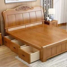 a wooden bed with drawers underneath it