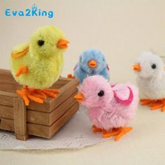 three small stuffed birds sitting on top of a table