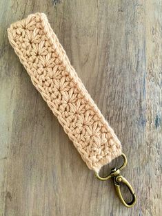 a crocheted key fob on a wooden surface