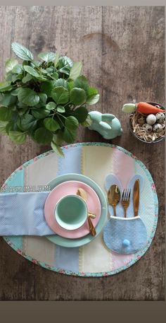 the table is set with dishes and utensils