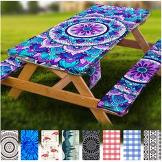 an outdoor picnic table with different patterns and colors on the cover is shown in front of grass