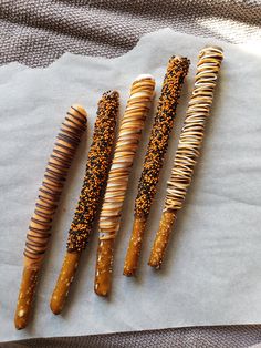 four different types of hair brushes on top of a piece of wax paper with sprinkles