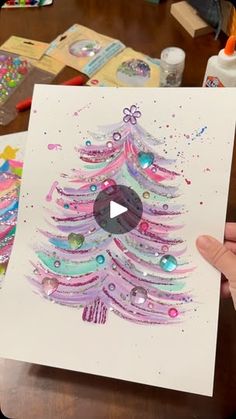 someone is holding up a christmas card with a tree on it and the video has been altered