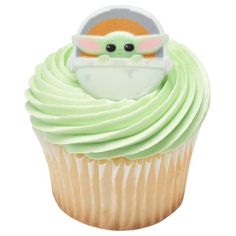 a cupcake with green frosting and a baby yoda on top