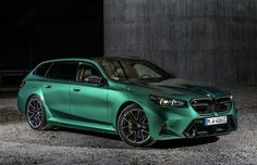 a green car parked in front of a building