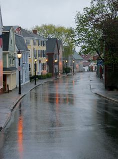 a wet street with buildings on both sides