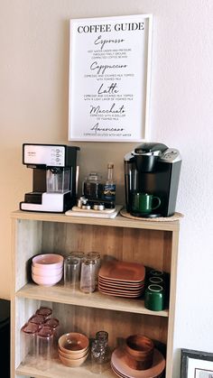 a shelf with coffee cups, plates and other kitchen items on it in front of a sign that says coffee guide