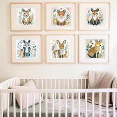 a baby's room with pictures on the wall and a crib in front of it