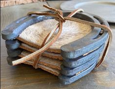 a pile of old shoes sitting on top of a wooden table