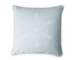 a snowflake pillow on a white background