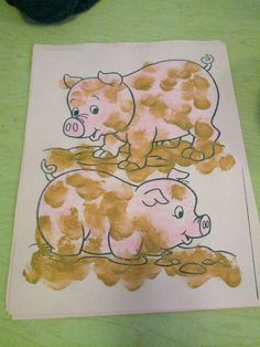 a drawing of two pigs sitting on top of a piece of paper