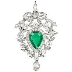 An Edwardian emerald and diamond pendant/brooch, the pear-shaped emerald, weighing approximately 2.20 carats, accompanied by GCS Report no:5777-8959 stating to be of Colombian origin with minor enhancement, surrounded by twenty two old brilliant-cut diamonds, surrounded by a diamond-set foliate design with a diamond-set bow at the top, all suspended by a diamond-set loop, approximate total diamond weight 4.20 carats, all set in a platinum to a yellow gold back with gold brooch fitting, circa 191 Bijoux Art Deco, Edwardian Jewelry, Cz Bracelet, Diamond Brooch, Deco Jewelry, Emerald Jewelry, Van Cleef, Art Deco Jewelry, Antique Jewellery