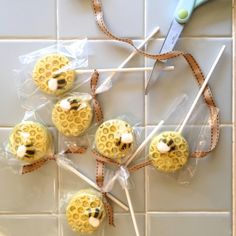 four honeybee cupcakes are wrapped in cellophane