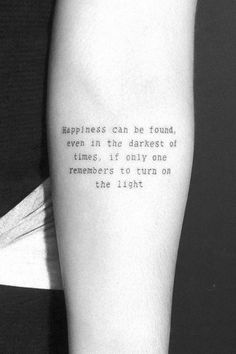 a person with a tattoo on their arm that says happiness can be found even in the darpett of times, if only one remembers to turn on the light